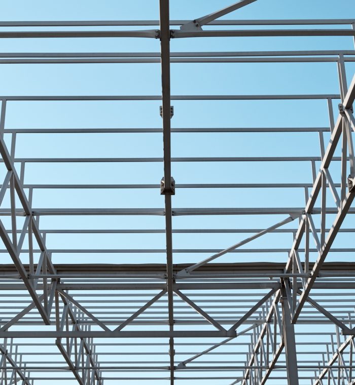 Metal constructions. Large warehouse building under construction